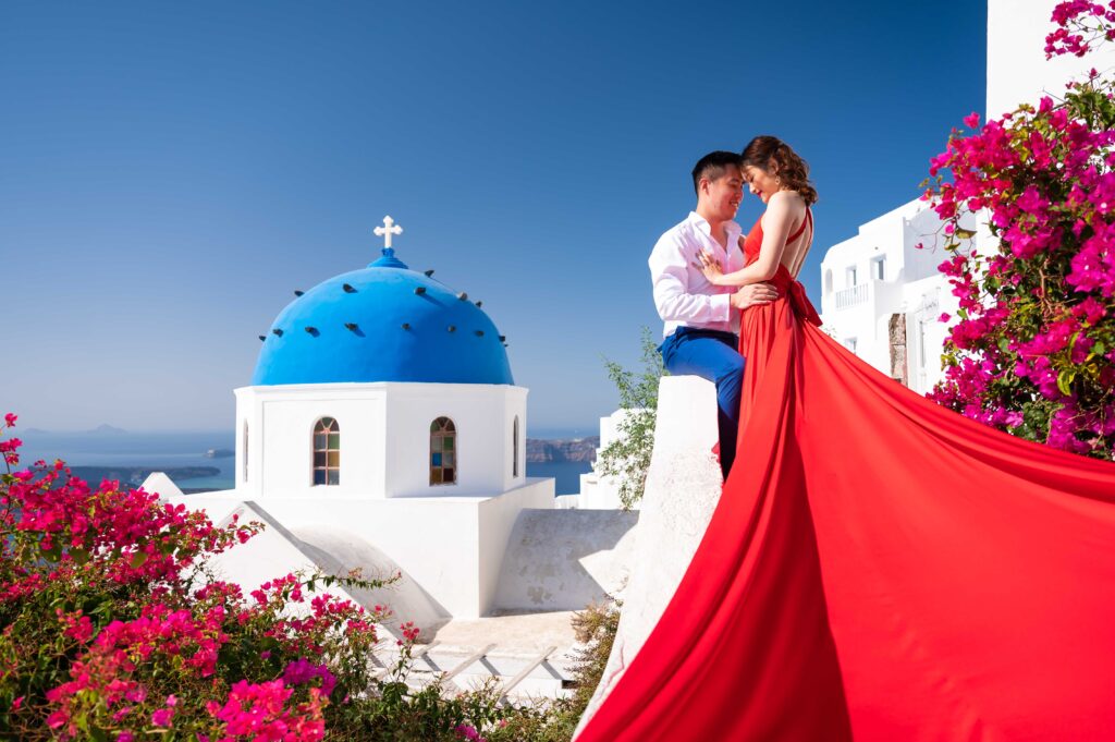 A beautiful photo of a woman in a flowing outfit, appearing as if she's about to fly away in the stunning surroundings of Santorini