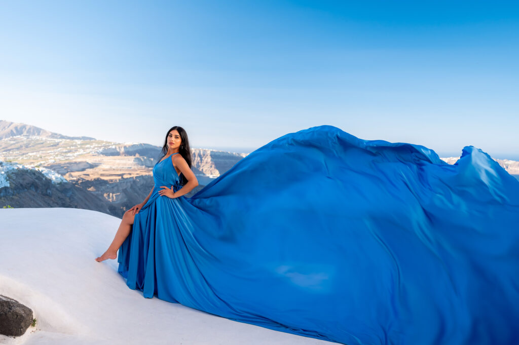 A pose with an open leg with an open blue sky in the background.