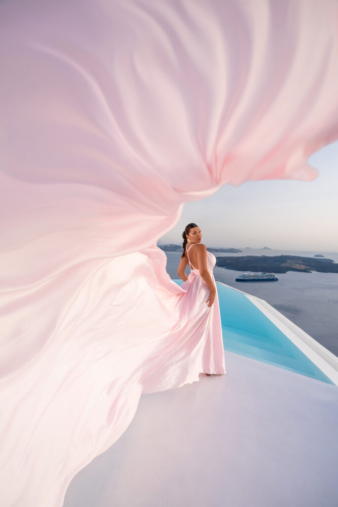 Girl standing while looking behind her back with a flying dress tale being in the air
